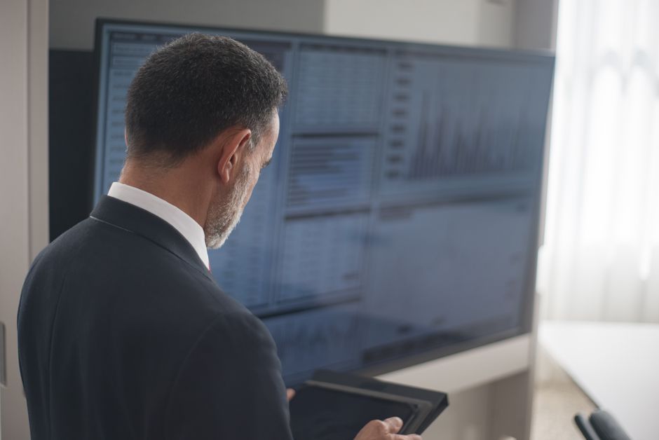 man viewing a tablet