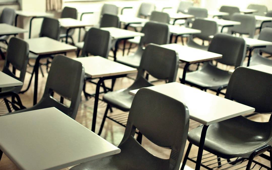 empty desks in a school room empty desks in a school room